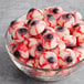 A glass bowl filled with Vidal gummy eyeball candies featuring red and black detailing.