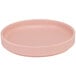 A pink round Cal-Mil melamine plate with a low rim.