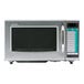 A silver Sharp commercial microwave with a black rectangular touch screen display.