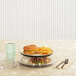 A burger and fries on a Cal-Mil Sophie ivory and black melamine plate.