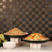 A table with ivory and black Cal-Mil Sophie melamine bowls of food.