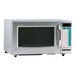 A silver Sharp medium-duty commercial microwave with a black screen and white text.