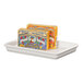 A white rectangular Cal-Mil melamine serving tray holding two rectangular boxes of fish.