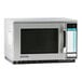A stainless steel Sharp commercial microwave with a black screen.