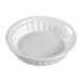 A white fluted porcelain mini dish with a scalloped edge.
