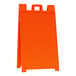An orange sign with a white handle.
