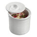 A white Solia porcelain tin can mini dish with an open lid filled with food.