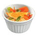 A Solia white fluted porcelain mini dish filled with orange slices and mint leaves.