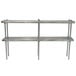 A stainless steel table mounted double deck shelving unit with a long metal rod.