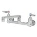 A T&S chrome wall mount pantry faucet with two handles and two faucets.