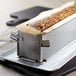 A loaf of bread in a de Buyer stainless steel loaf pan.