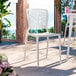 A white resin side chair with a webbed back design.