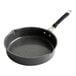 A black saute pan with a speckled surface and silver handle.