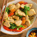 A bowl of Beyond Meat plant-based vegan unbreaded chicken pieces served with mixed vegetables and rice.