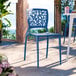 A navy blue resin side chair with a webbed back design.