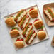 A VerTerra Balsa wood tray with hot dogs, cheese, and sauce.