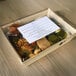 A VerTerra Balsa Wood tray with a lid on a table with food and drinks in it.
