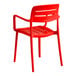 A red resin arm chair with a slat back and seat design.