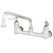 A chrome T&S wall mounted pantry faucet with two levers.