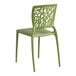 A green resin side chair with a webbed back design.