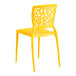 A yellow resin side chair with a webbed back design.