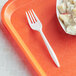 A white plastic fork on a tray.