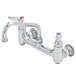 A T&S chrome wall mount pantry faucet with two handles and two faucets.