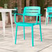 A coastal blue resin arm chair with a slat back design.