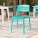 A coastal blue resin side chair with a slat back design.