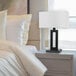 A modern 20-inch table lamp with a matte black geometric base and a white linen rectangular shade.
