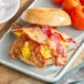 A bagel sandwich with Hatfield Chef Choice bacon and eggs on a plate.