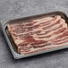 Tender Belly Applewood Double Smoked Sliced Bacon in a tray.