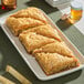 A plate of Kontos fillo dough pastries on a table.