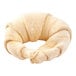 Croissant dough with a buttery texture pinched into a croissant shape.