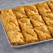 A tray of Kontos Classic Baklava on a gray surface.