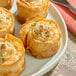 A plate of food topped with Kontos Fillo pastry cups.