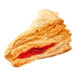 A turnover pastry with cherry jam on it.