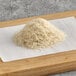 A pile of shredded noodles on a wooden board.