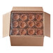 A Pillsbury chocolate brownie cup with caramel drizzle in a cardboard box.
