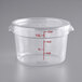 A clear round polycarbonate food storage container with a lid and red measurement markings up to 12 quarts or 10 liters.