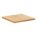 A Cal-Mil square oak wood serving board on a wood surface.