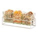 A Cal-Mil chrome condiment display with three square glass jars filled with citrus slices.