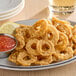 A plate of Jinka plant-based breaded calamari with sauce and lemon.