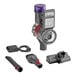 A Dyson black and red cordless hand vacuum with a brush attachment.