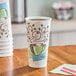 A Dixie PerfecTouch paper hot cup with a straw in it on a counter.