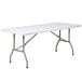 A Lancaster Table & Seating granite white rectangular table with metal legs.