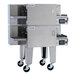 A double stacked stainless steel electric impinger conveyor oven with two wide belts and caster wheels.