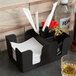 A black Choice bar caddy with a drink and straw on a counter.