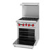 An American Range stainless steel 4-burner range with a red oven.