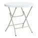 A round, white plastic folding table with gray metal legs.